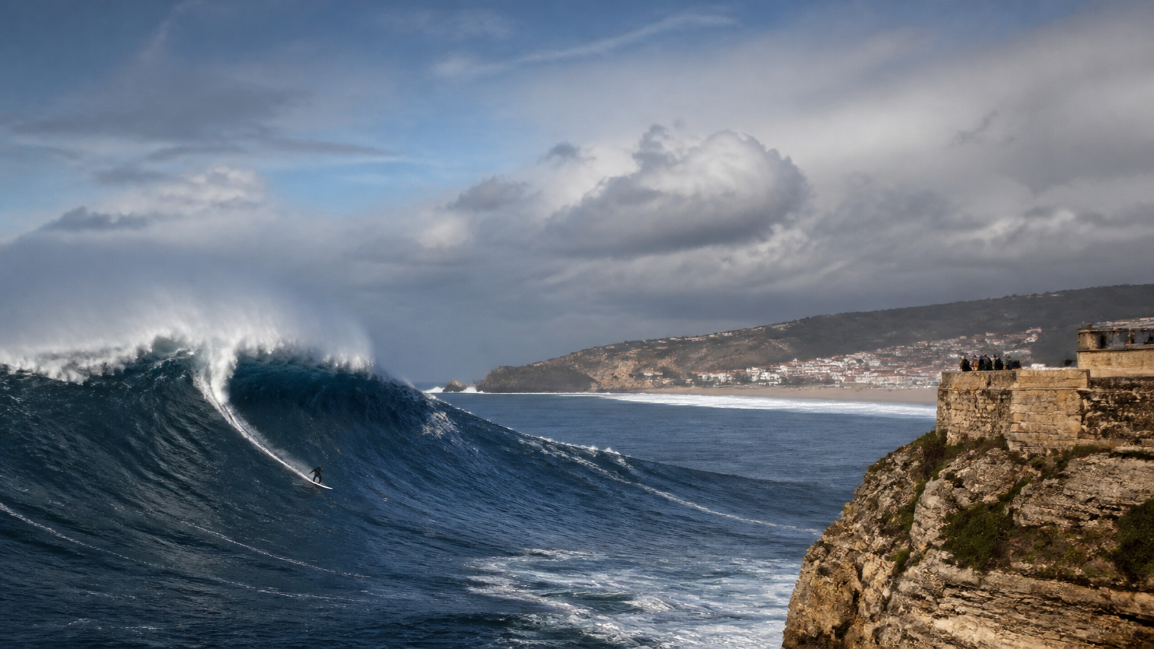 A giant Atlantic wave and surfer at Praia do Norte, Nazaré